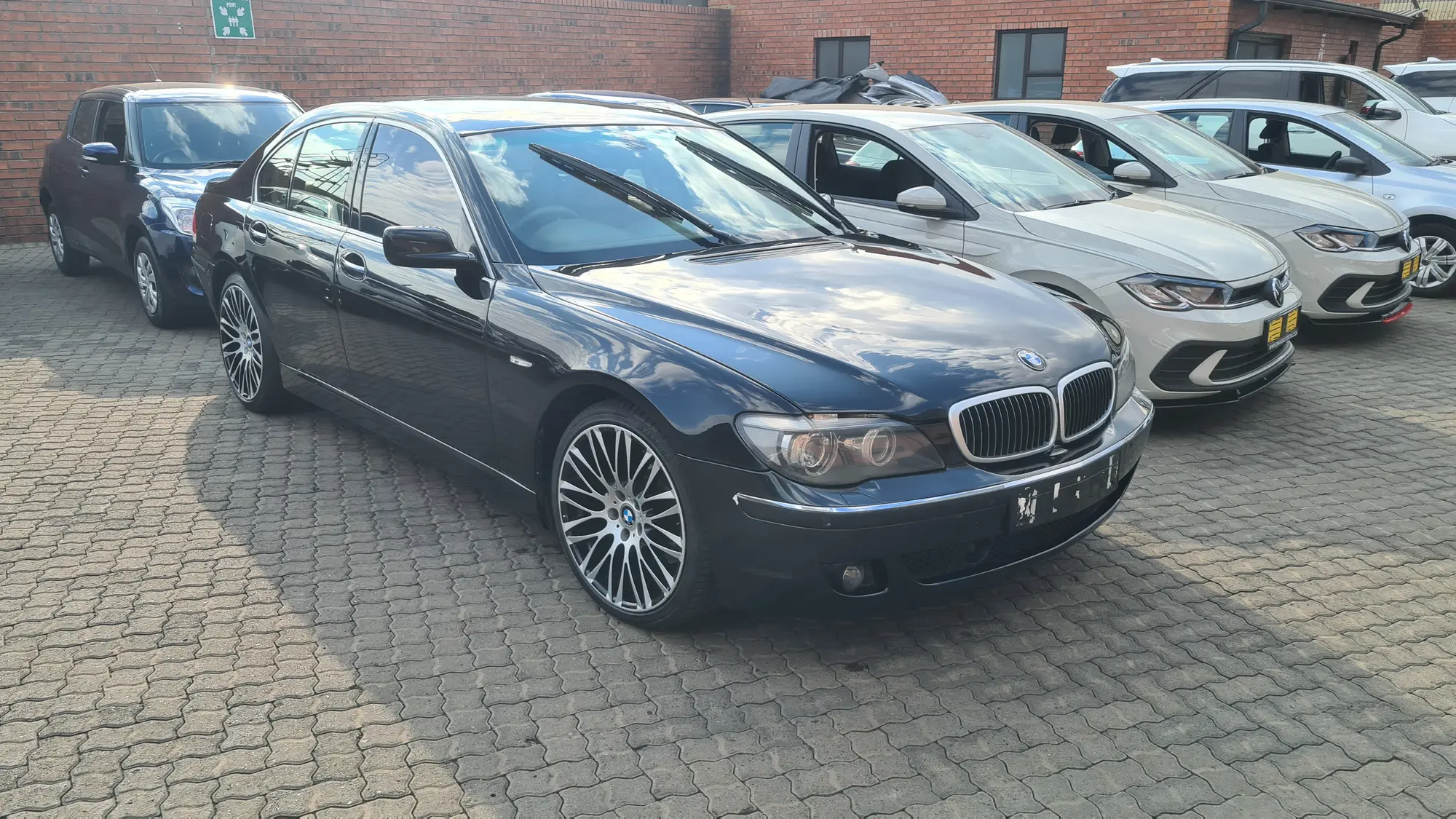 A black BMW 7 Series photographed from the front quarter after detailing