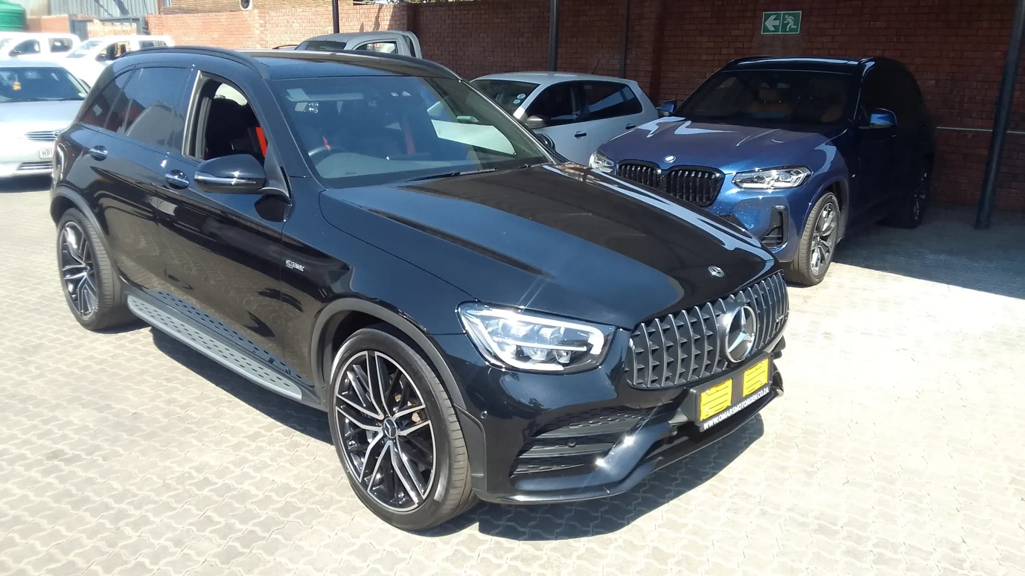 A black Mercedes-AMG GLC 43 photographed from the front quarter after detailing