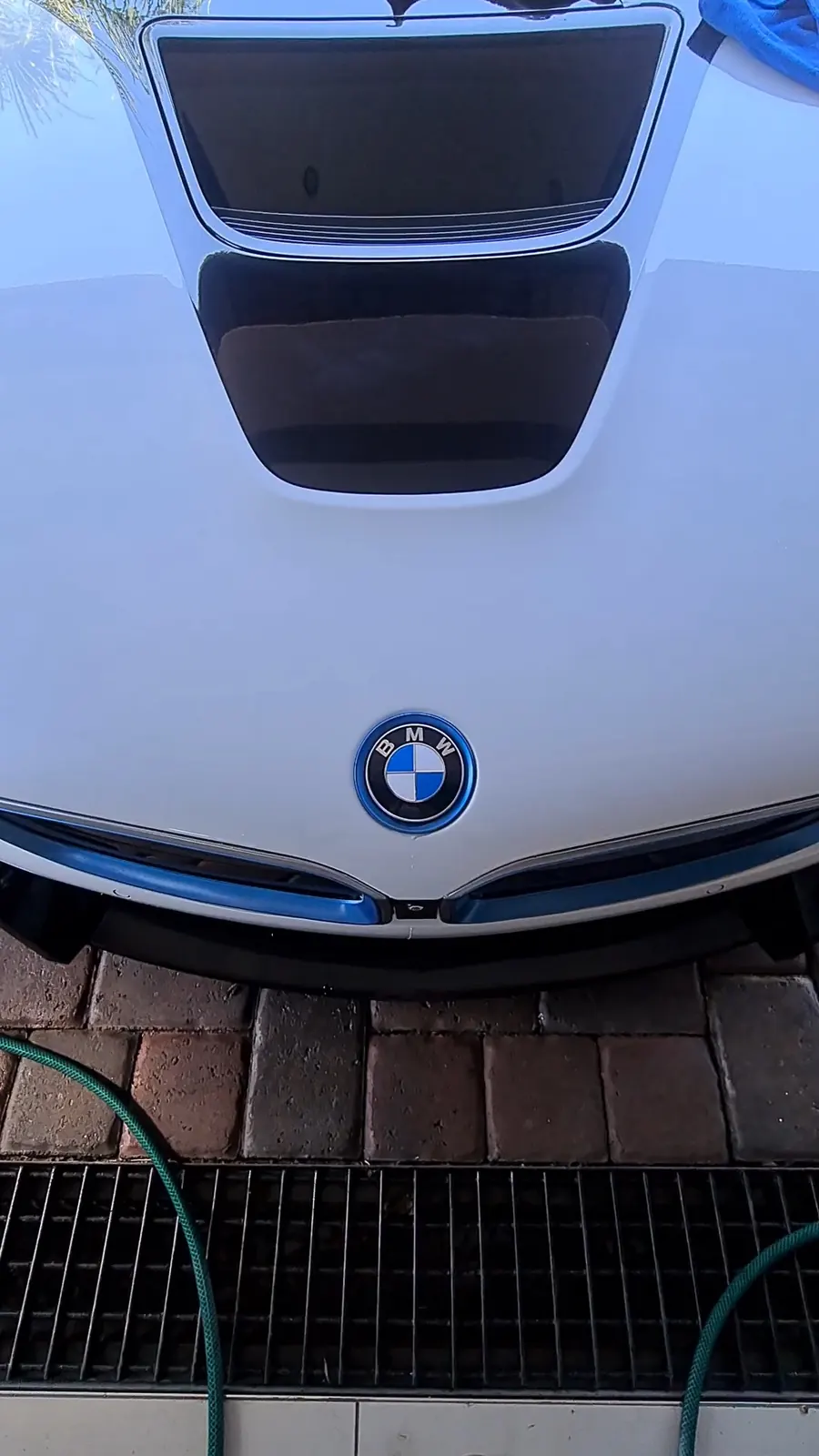 The nose and bonnet vent of a BMW i8 after detailing, photographed square on