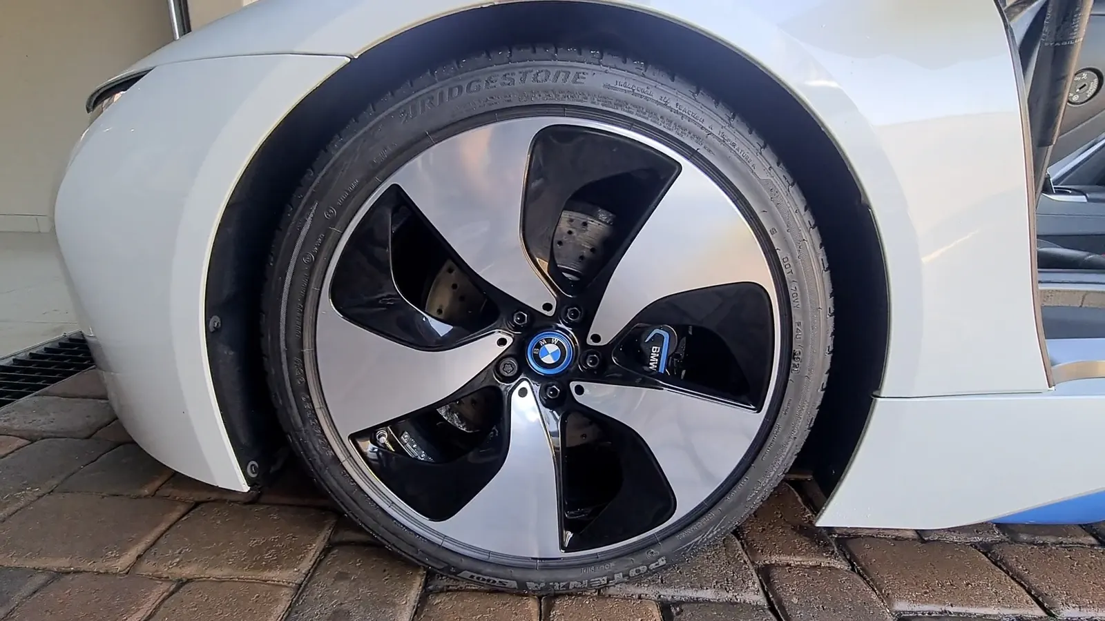 The front wheel and arch of a BMW i8 after detailing