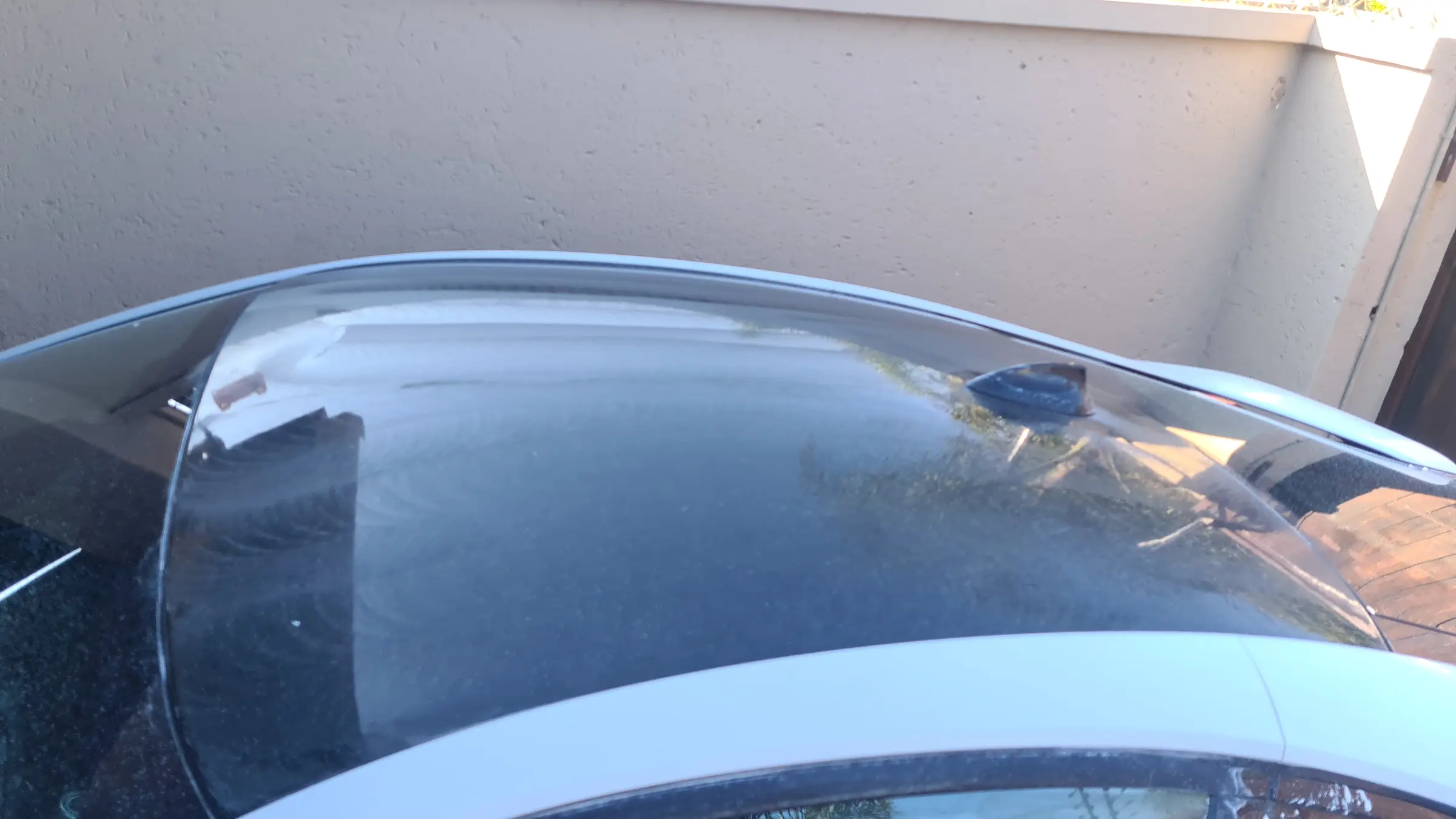 The bonnet and windscreen of a BMW i8 before correction