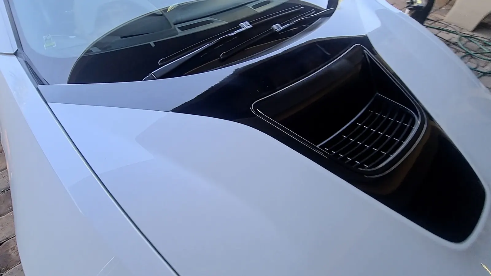 The bonnet vent and surrounding paint of a BMW i8 before correction, the finish flat and dull