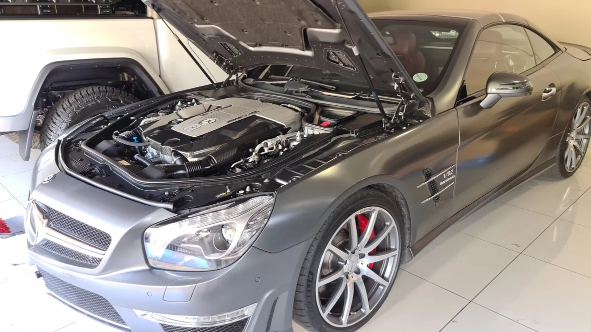 A Mercedes-AMG SL 65 with the bonnet raised after detailing, photographed from the front quarter