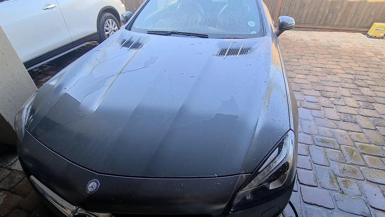 The coated bonnet and wing of a Mercedes-AMG SL 65, the surface returning one clean reflection