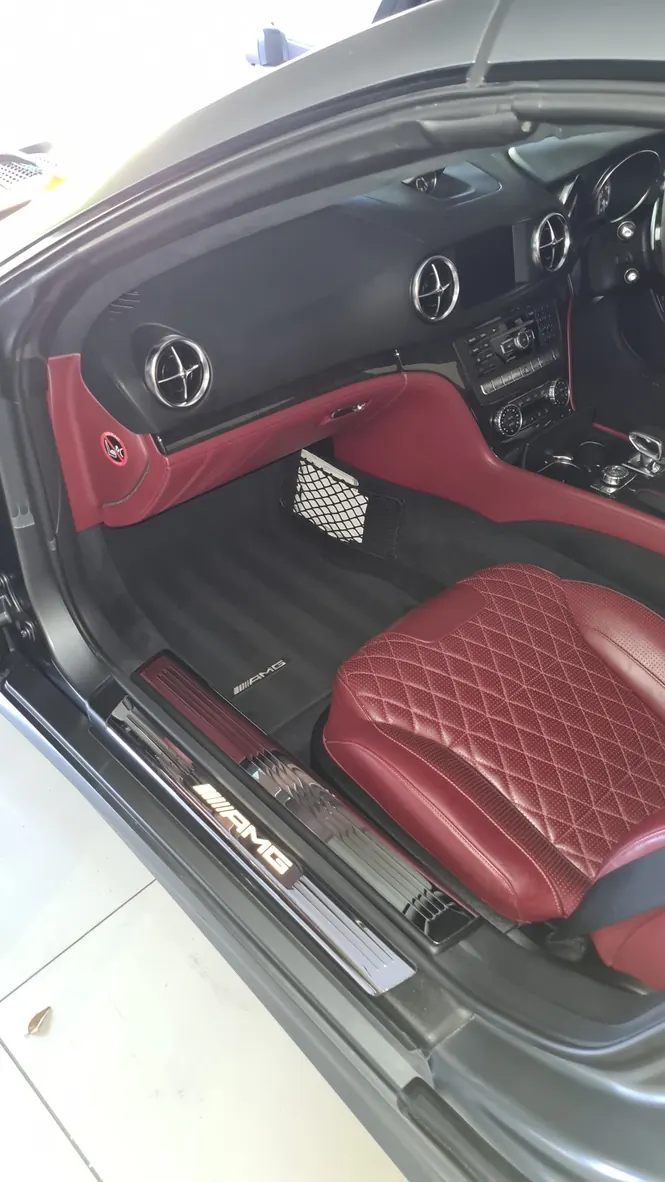 The red quilted seats, sill and floor of a Mercedes-AMG SL 65 after an interior detail