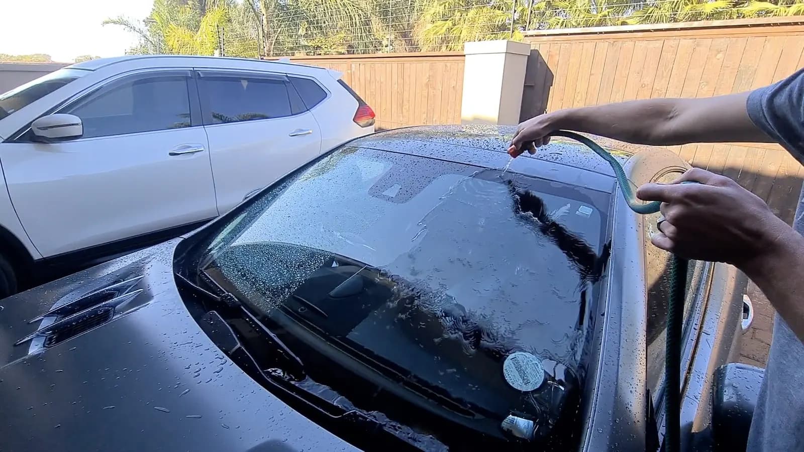 A ceramic glass coating being worked across a windscreen with a block applicator