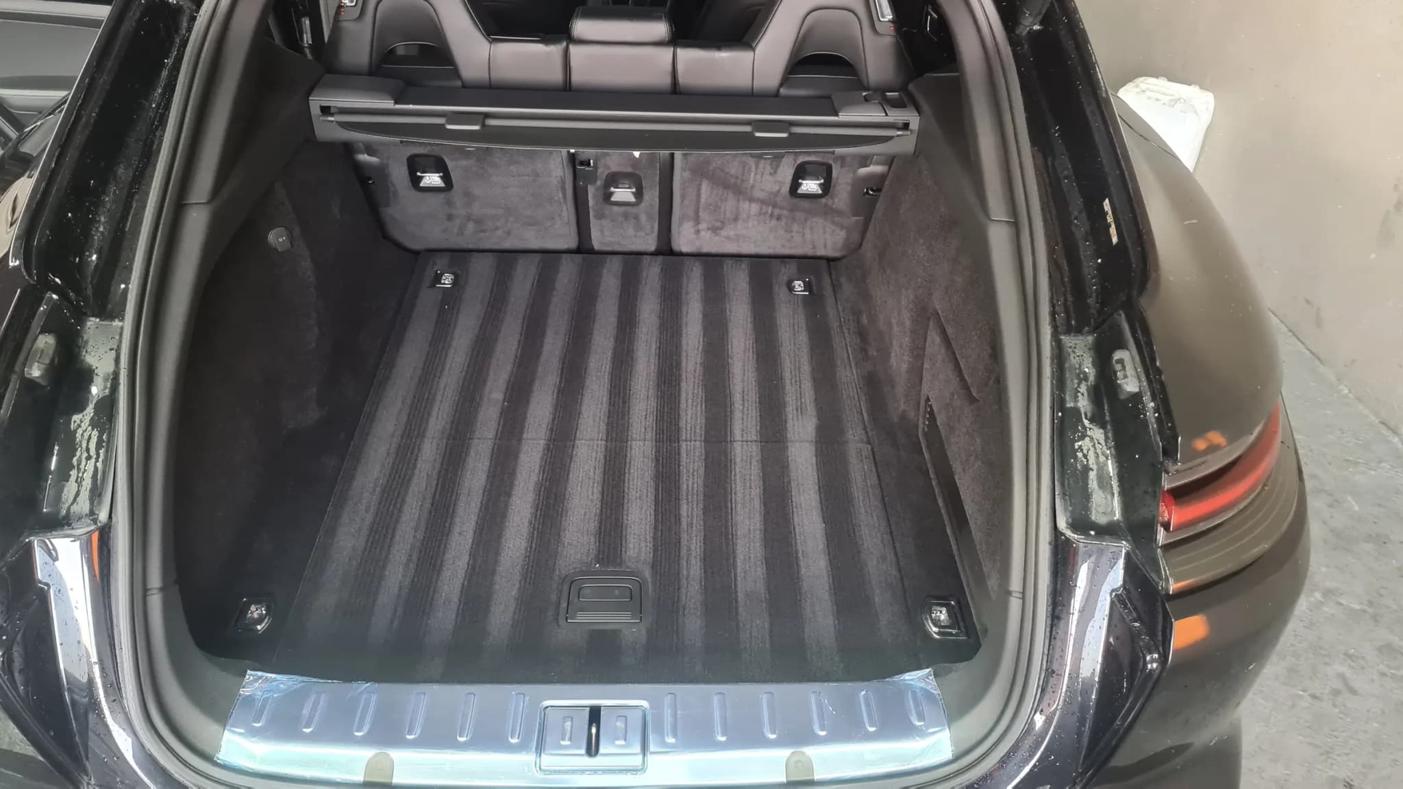 The boot floor and carpet of a Porsche Panamera after hot-water extraction, the pile lifted and even