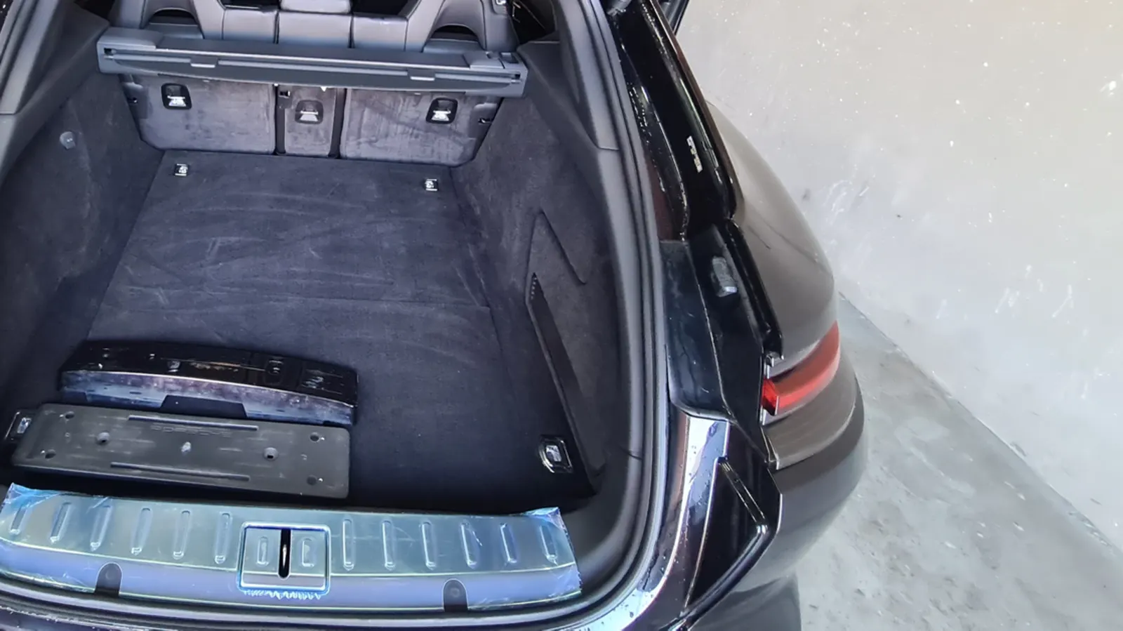 The open boot of a Porsche Panamera before the carpet was extracted